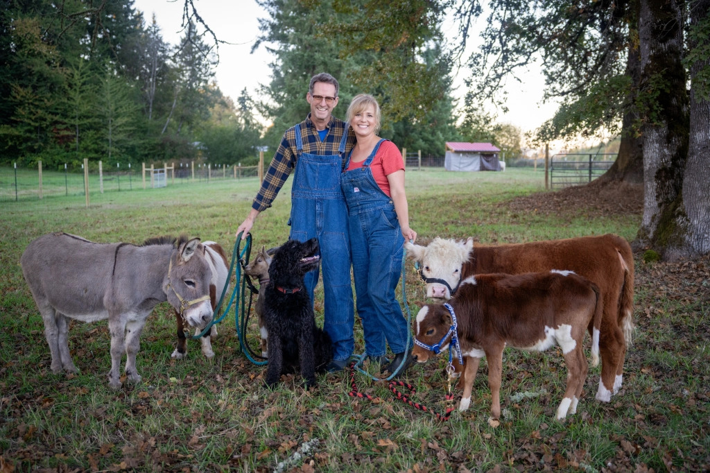 the owners, michele and randy, standing with their animals